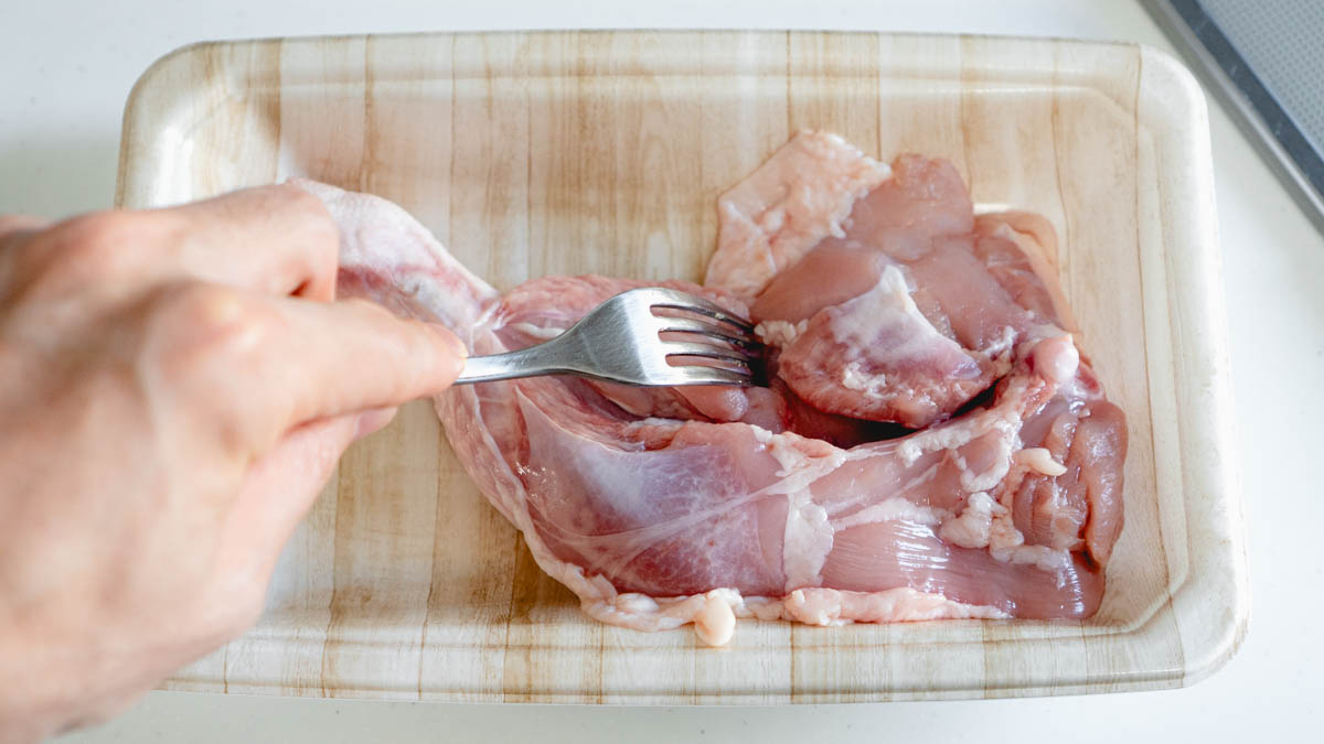 骨付き鶏もも肉にフォークで穴をあける